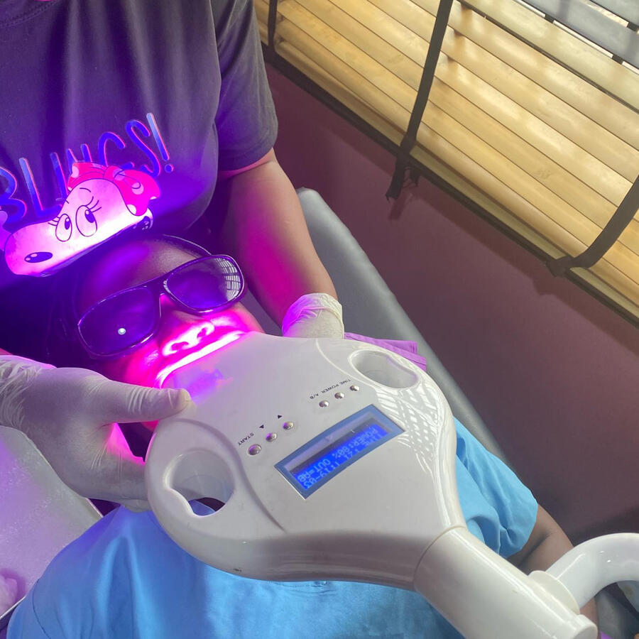 Picture of a lady getting a teeth whitening treatment